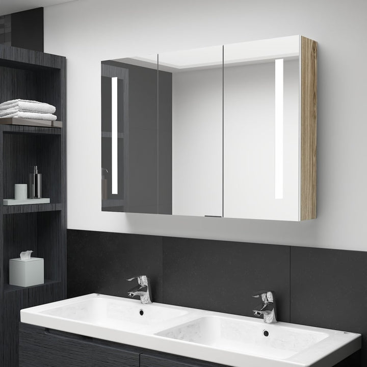 badeværelsesskab med spejl + LED-lys 89x14x62 cm hvid og egetræ