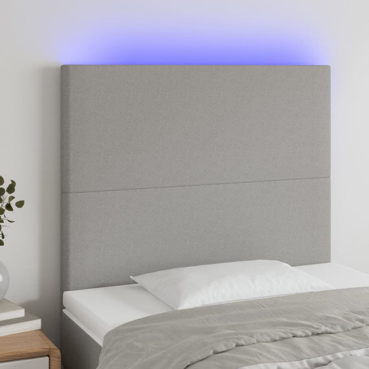 sengegavl med LED-lys 80x5x118/128 cm stof lysegrå
