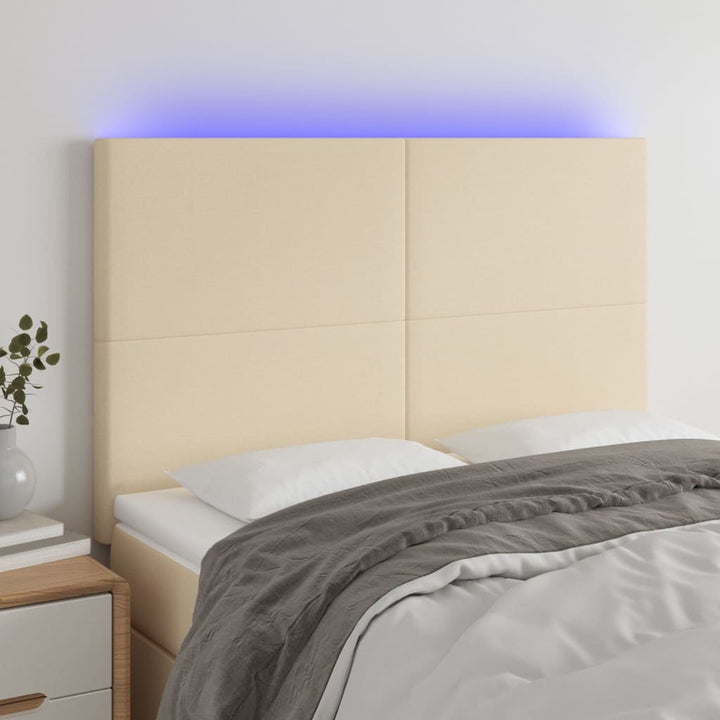 sengegavl med LED-lys 144x5x118/128 cm stof cremefarvet