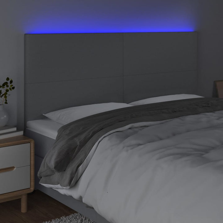 sengegavl med LED-lys 160x5x118/128 cm stof lysegrå