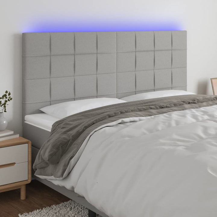 sengegavl med LED-lys 200x5x118/128 cm stof lysegrå