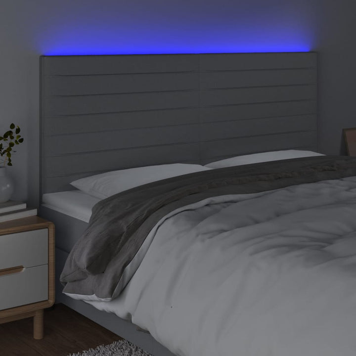 sengegavl med LED-lys 160x5x118/128 cm stof lysegrå
