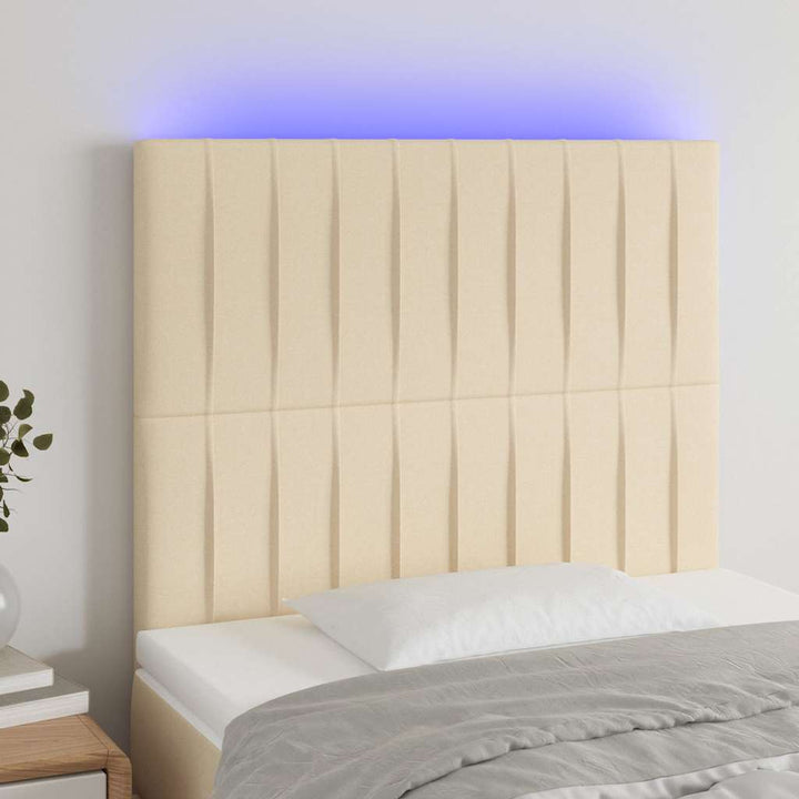 sengegavl med LED-lys 90x5x118/128 cm stof cremefarvet