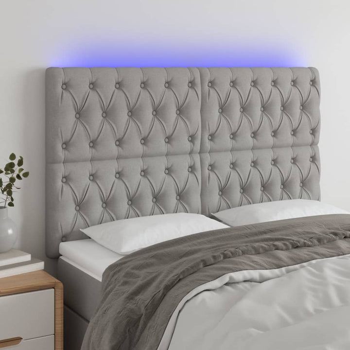 sengegavl med LED-lys 160x7x118/128 cm stof lysegrå