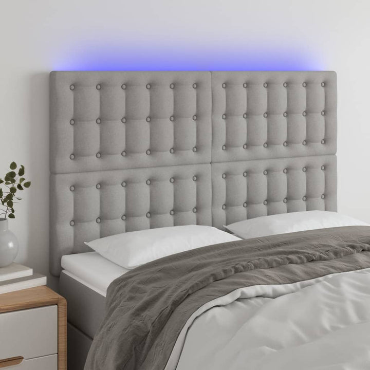 sengegavl med LED-lys 144x5x118/128 cm stof lysegrå