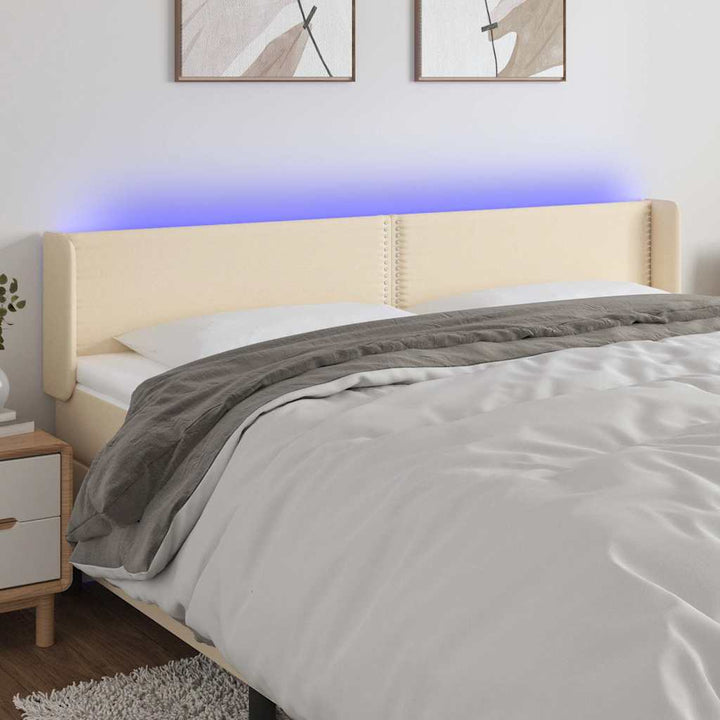 sengegavl med LED-lys 203x16x78/88 cm stof cremefarvet