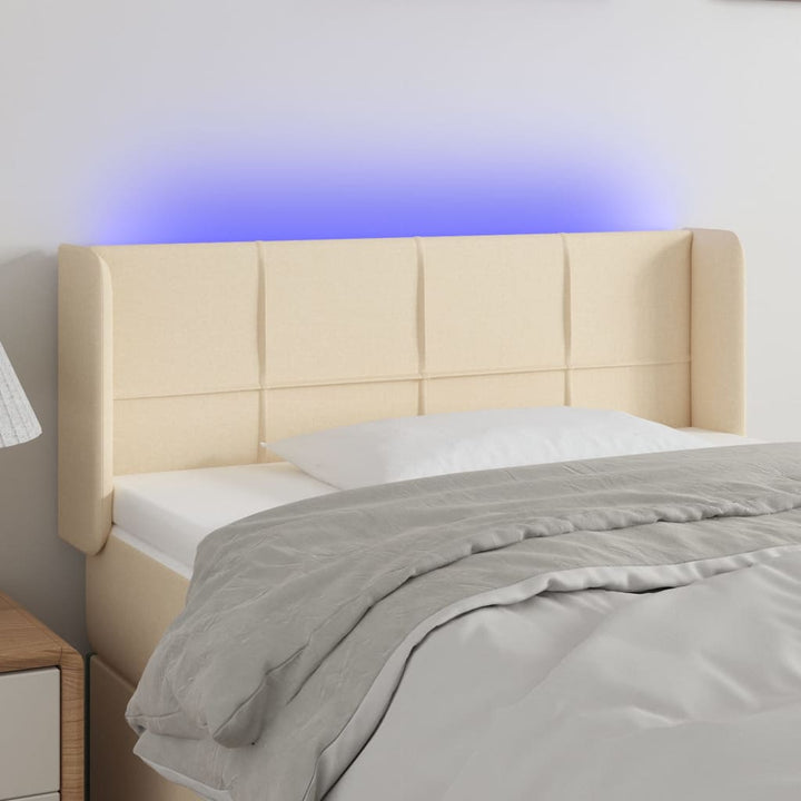 sengegavl med LED-lys 93x16x78/88 cm stof cremefarvet