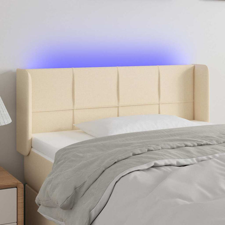 sengegavl med LED-lys 103x16x78/88 cm stof cremefarvet