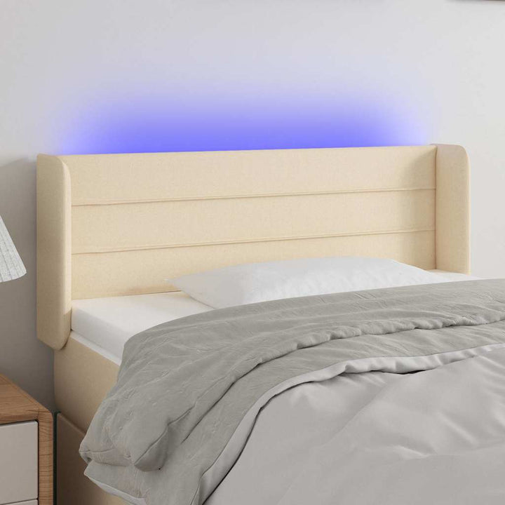 sengegavl med LED-lys 103x16x78/88 cm stof cremefarvet