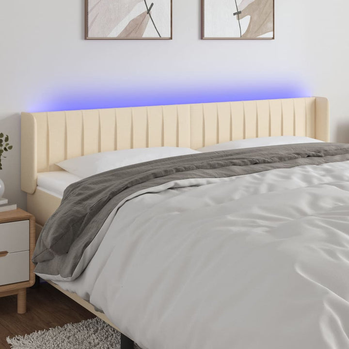 sengegavl med LED-lys 163x16x78/88 cm stof cremefarvet