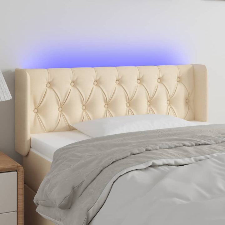 sengegavl med LED-lys 93x16x78/88 cm stof cremefarvet