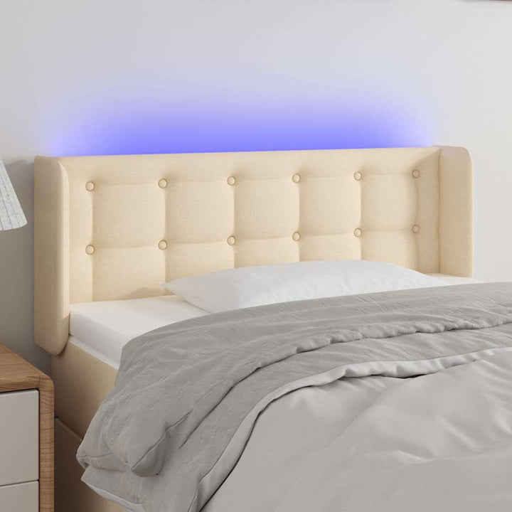sengegavl med LED-lys 83x16x78/88 cm stof cremefarvet