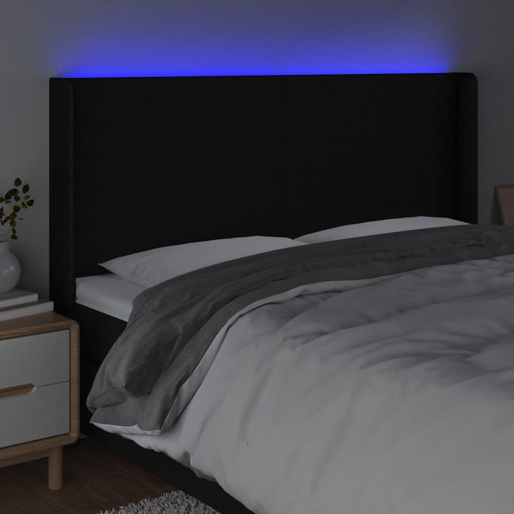 sengegavl med LED-lys 163x16x118/128 cm stof sort