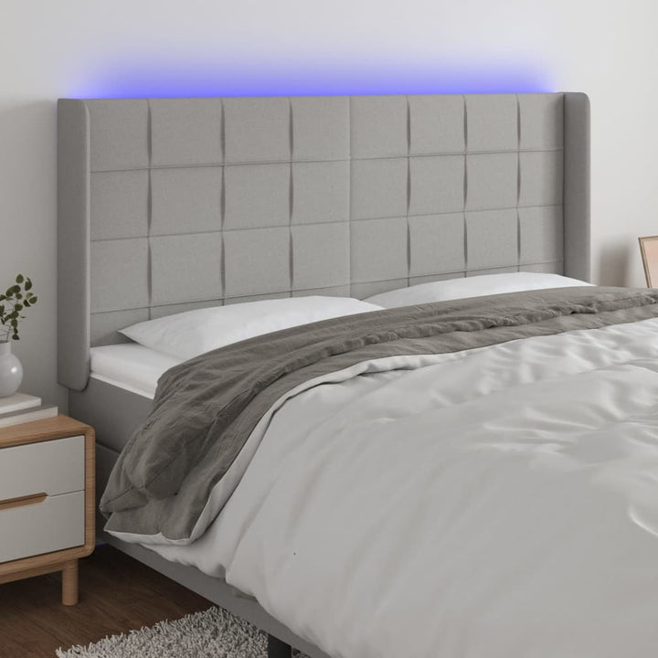 sengegavl med LED-lys 183x16x118/128 cm stof lysegrå