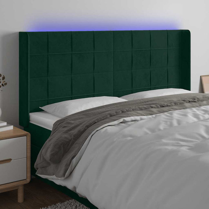 sengegavl med LED-lys 163x16x118/128 cm fløjl mørkegrøn