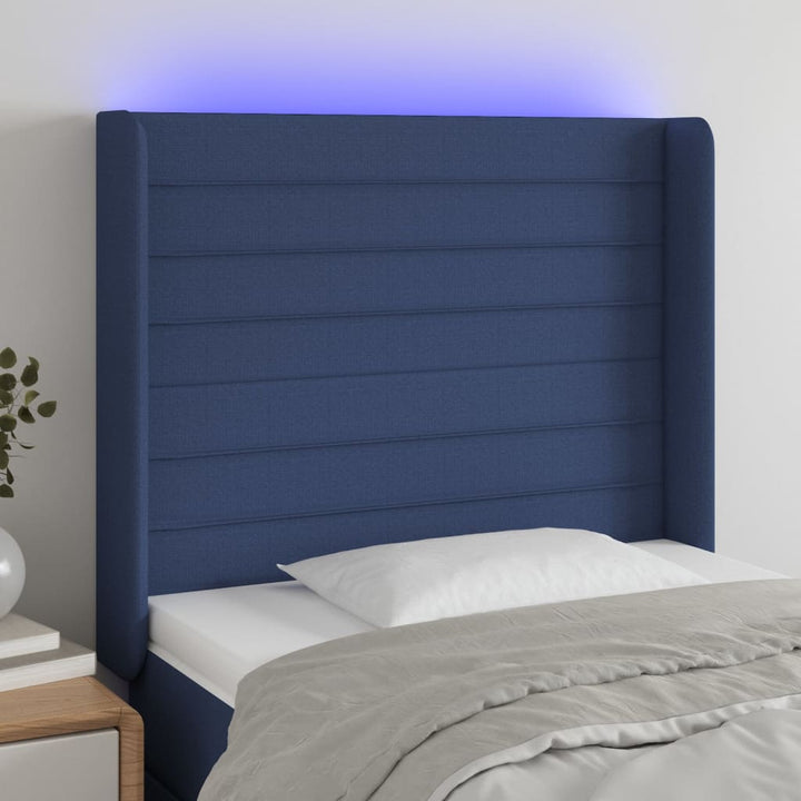 sengegavl med LED-lys 83x16x118/128 cm stof blå
