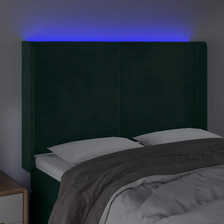 sengegavl med LED-lys 147x16x118/128 cm fløjl mørkegrøn
