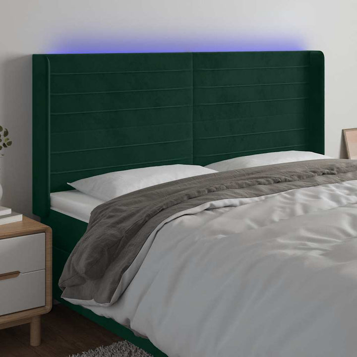 sengegavl med LED-lys 203x16x118/128 cm fløjl mørkegrøn