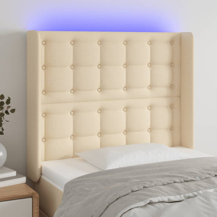 sengegavl med LED-lys 83x16x118/128 cm stof cremefarvet