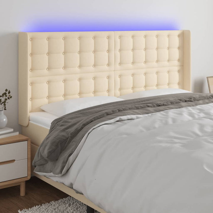 sengegavl med LED-lys 203x16x118/128 cm stof cremefarvet