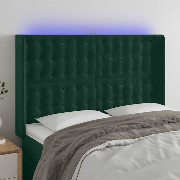 sengegavl med LED-lys 147x16x118/128 cm fløjl mørkegrøn