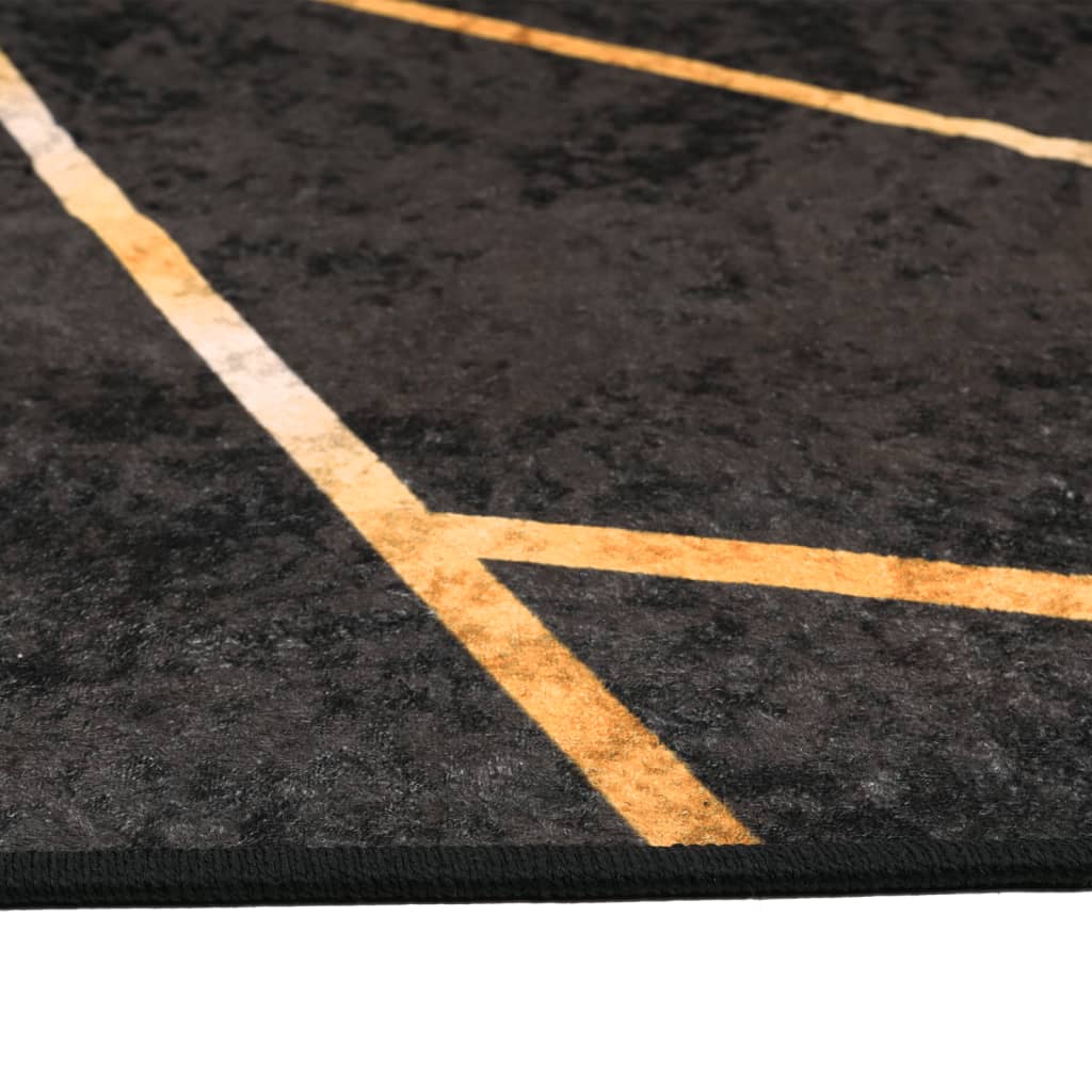 gulvtæppe 160x230 cm vaskbart og skridsikkert sort + guldfarvet